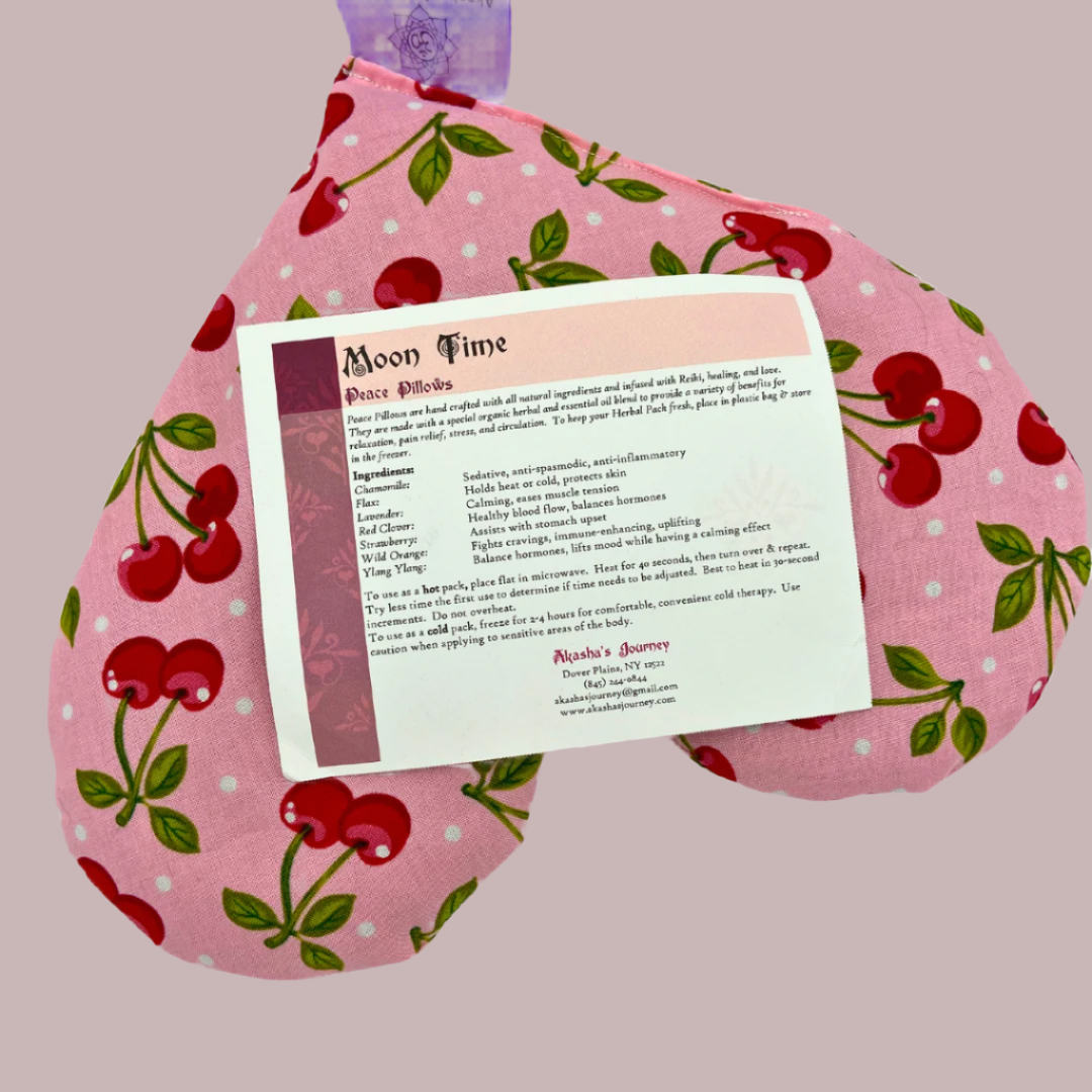 Image of Moon time peace pillow instruction sheet placed on top of heart shaped pink with cherries moontime pillow