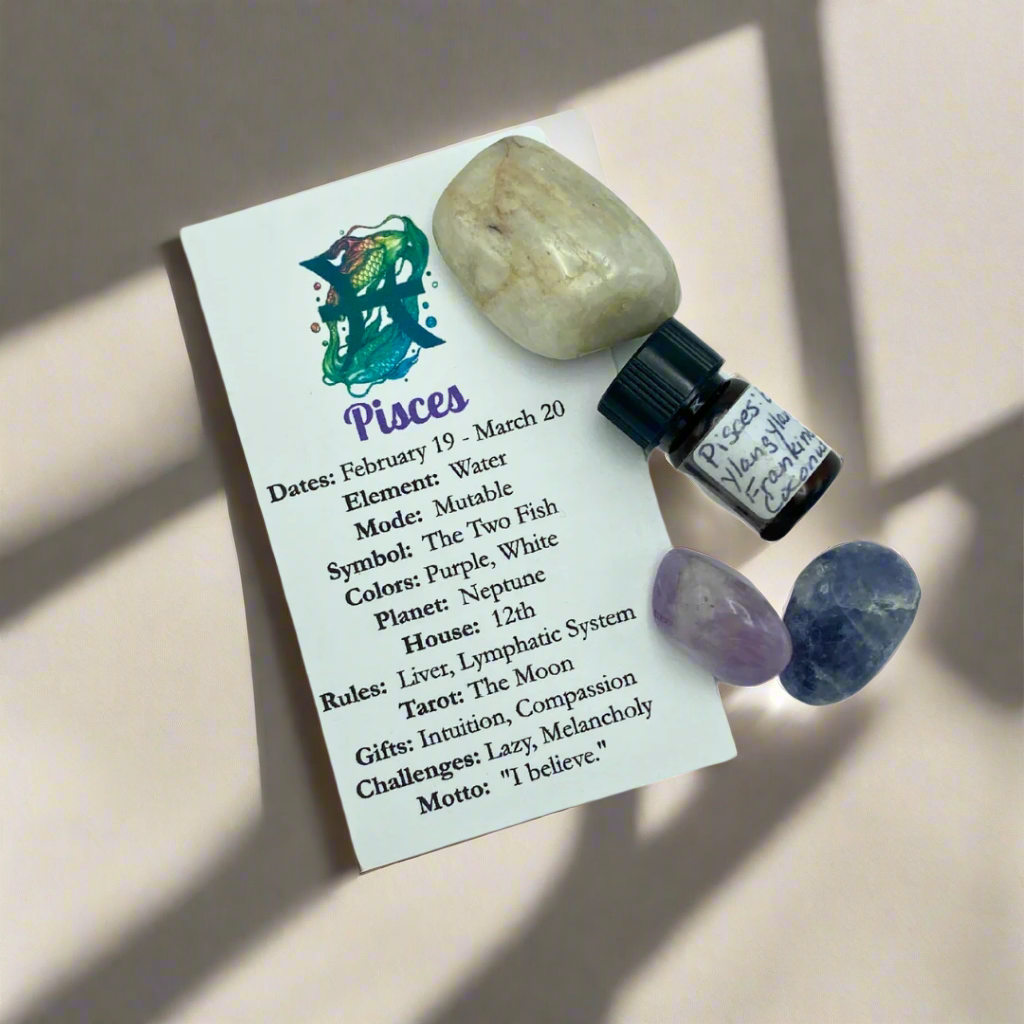 A collection of crystals and essential oils arranged under the lighting, with descriptive cards detailing the properties of each item for a Pisces Zodiac theme.