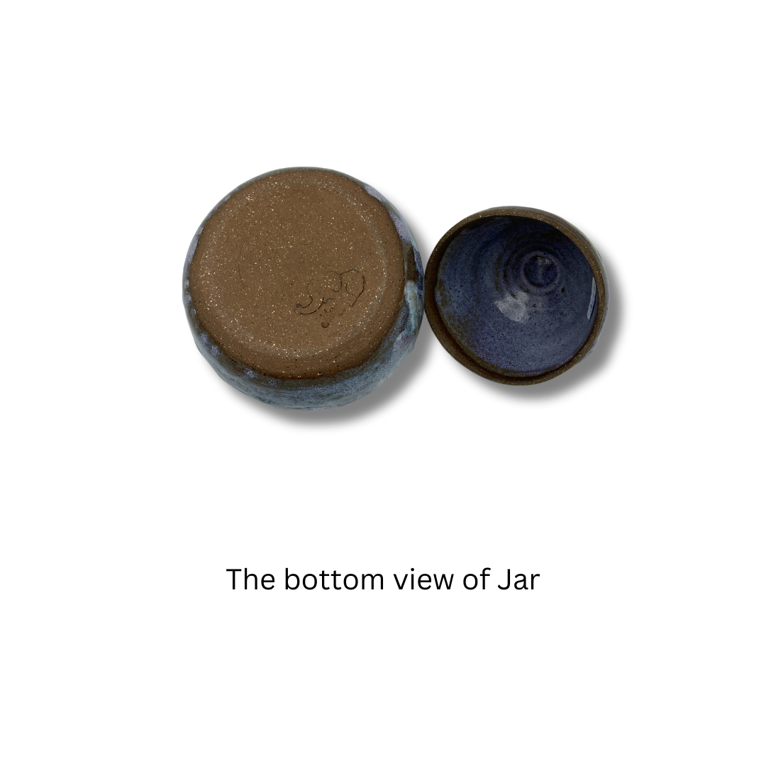bottom view ofof A handmade ceramic keepsake jar with a purple and blue color scheme, on a white background.