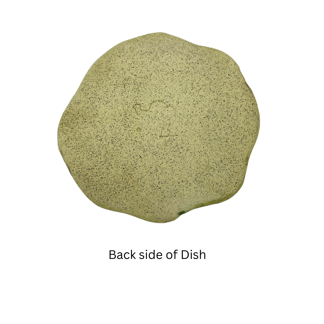 bottom view of A medium-sized, flower-shaped trinket dish with a creamy base color and grey/green veining.