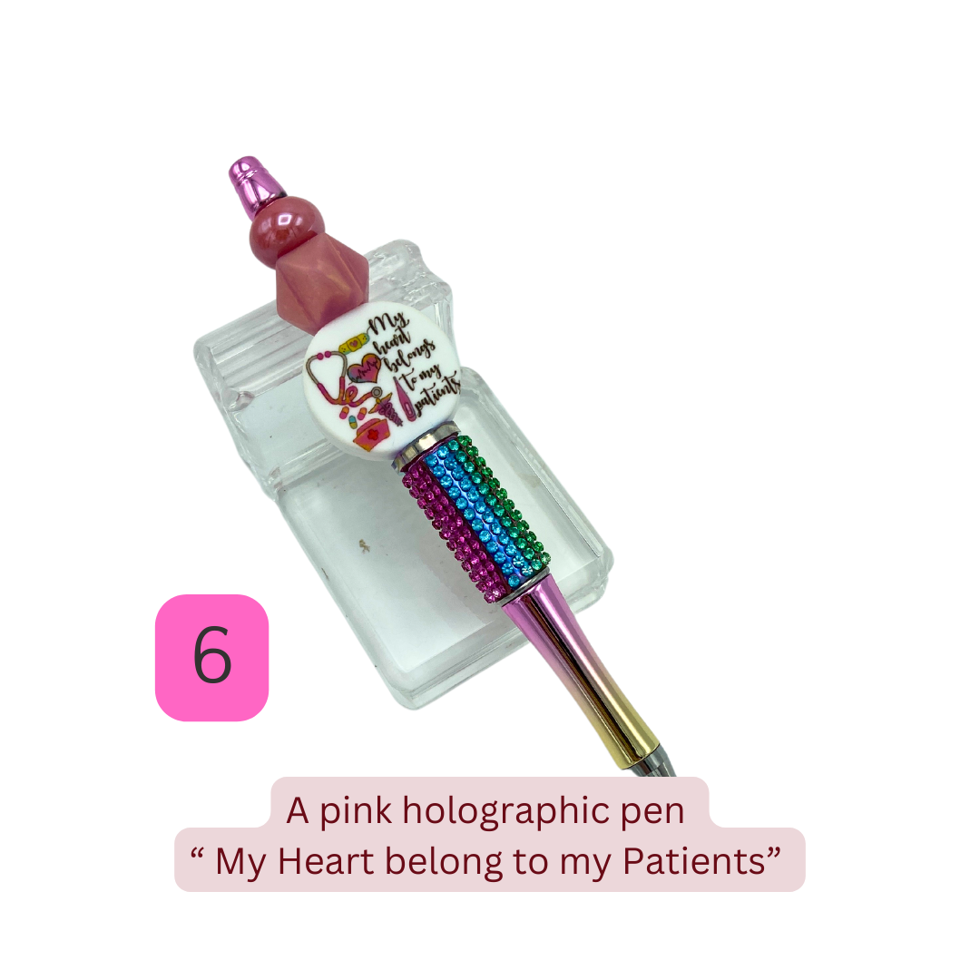 A collection of colorful handmade beaded pens with various healthcare-themed designs displayed on a stand.