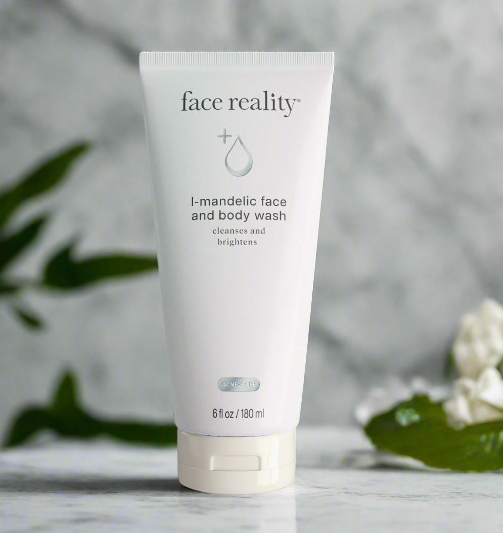 A tube of Face Reality L-Mandelic Face and Body Wash placed on a surface with a plant in the background.