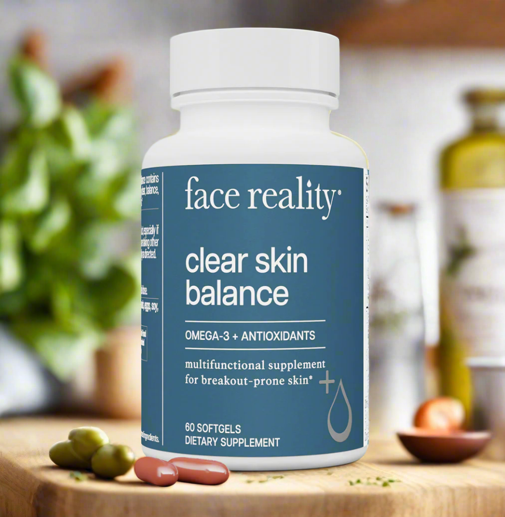 A bottle of Face Reality Clear Skin Balance supplements with softgels visible, placed on a wooden surface with a blurred background of kitchen essentials.