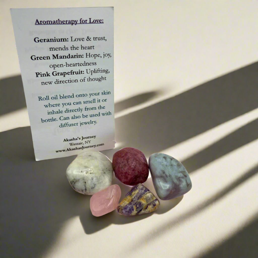 various small crystals, with a card labeled 'Love Mojo' explaining the product's purpose for manifesting love and enhancing emotional well-being.