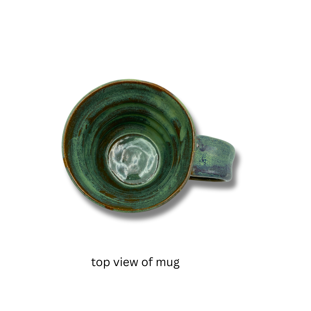 Top view of A handcrafted green ceramic mug with a textured surface and handle,