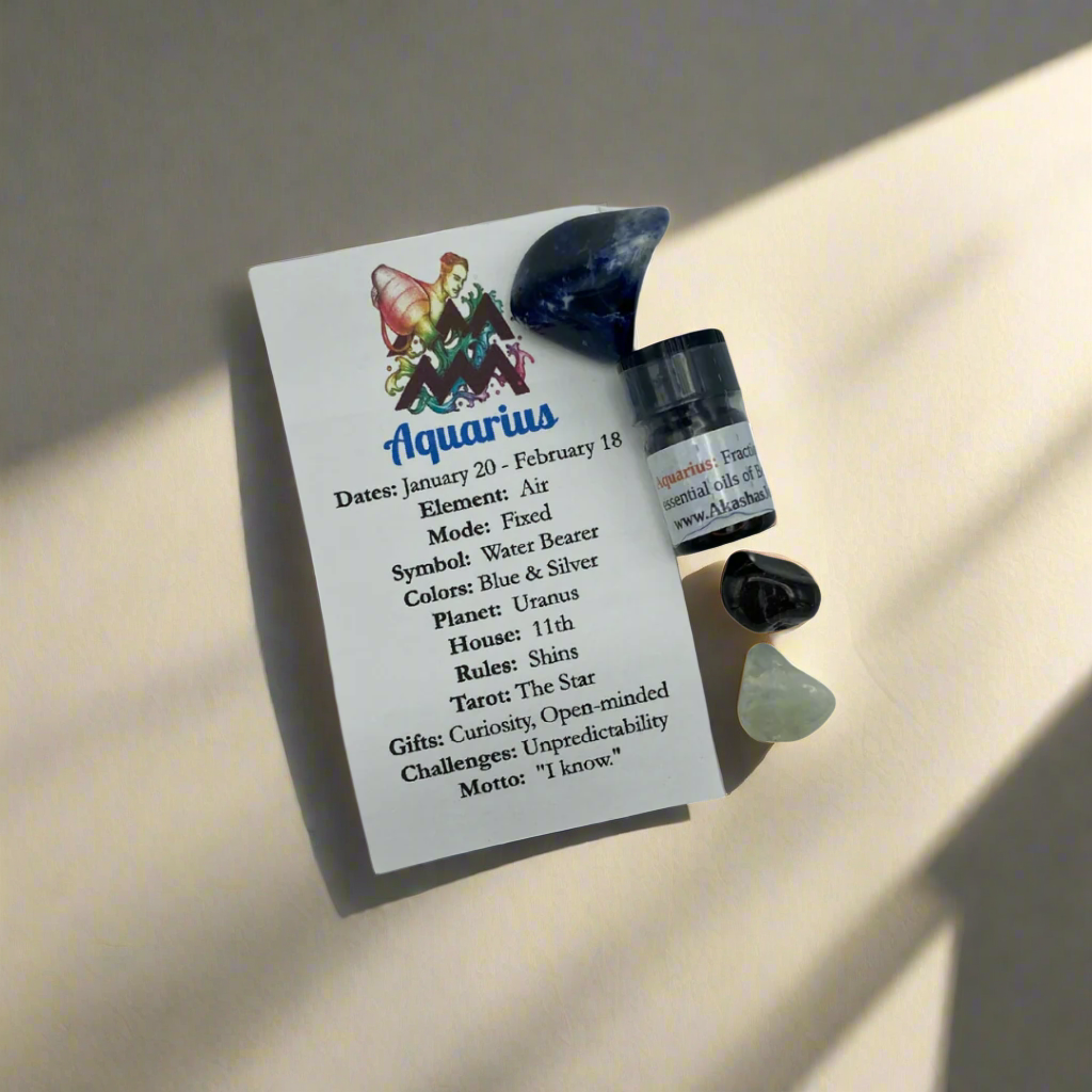 a selection of crystals and essential oils labeled for Aquarius zodiac sign, along with a card detailing the crystal and essential oil properties.