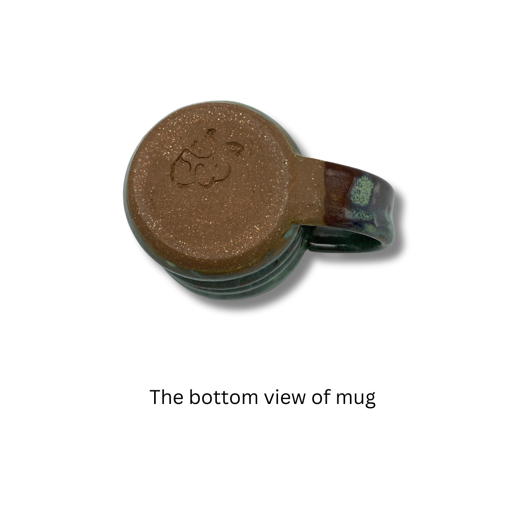 The bottom view of A handcrafted green ceramic mug with a textured surface and handle,