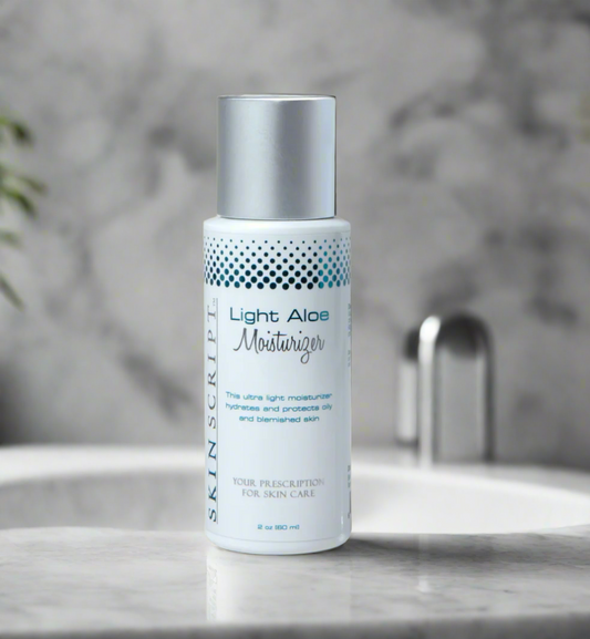 A pump bottle of SKINSCRIPTS Light Aloe Moisturizer on a marble surface with a blurred background.