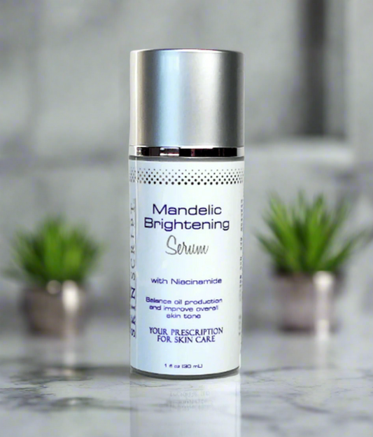 A bottle of SKINSCRIPTS Mandelic Brightening Serum with key ingredients listed, placed on a marble surface with two small potted plants in the background.