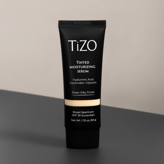 A tube of TiZO Tinted Moisturizing Serum with hyaluronic acid, ceramides, and glycerin, offering broad-spectrum SPF 30 sunscreen in a sheer finish.